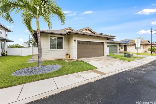 view of front of property with fence, central air condition unit, concrete driveway, a front yard, and an attached garage