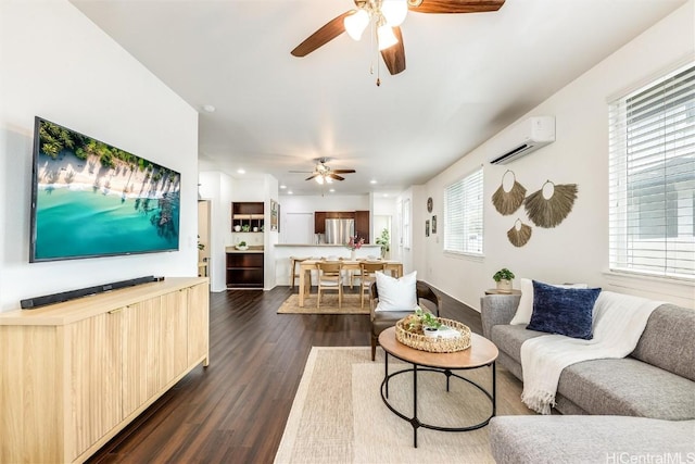 living room with recessed lighting, a ceiling fan, dark wood-type flooring, and a wall unit AC