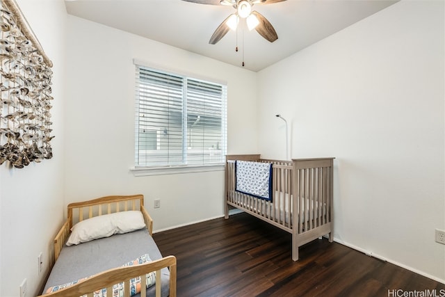 bedroom featuring baseboards, wood finished floors, and a ceiling fan