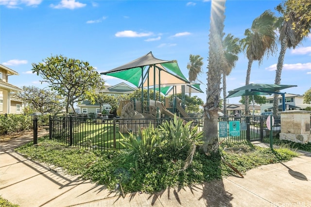 view of home's community with fence and playground community