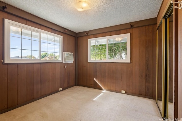94-1377 Hiaai Pl, Waipahu, HI 96797 - carpeted spare room with wooden walls, an AC wall unit, and a textured ceiling