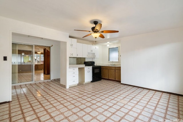 94-1377 Hiaai Pl, Waipahu, HI 96797 - kitchen with white cabinets, black range with electric stovetop, light countertops, light floors, and a sink