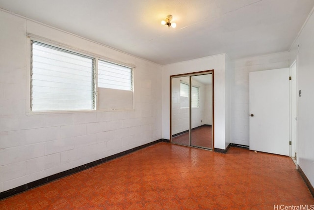 94-1377 Hiaai Pl, Waipahu, HI 96797 - unfurnished bedroom with multiple windows, a closet, and concrete block wall