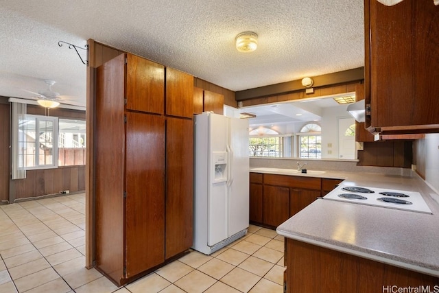 94-1377 Hiaai Pl, Waipahu, HI 96797 - kitchen with white fridge with ice dispenser, electric cooktop, plenty of natural light, and light countertops