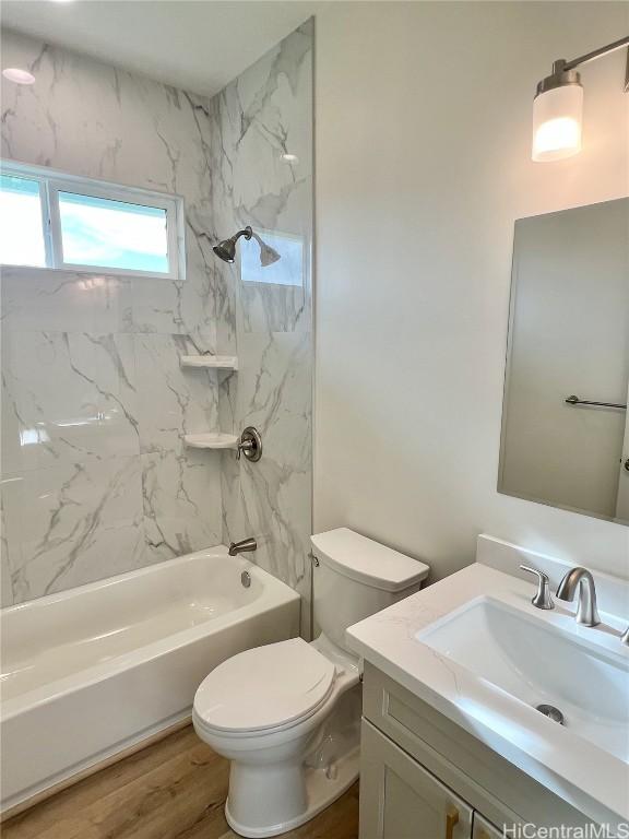 full bathroom featuring vanity, shower / bathing tub combination, toilet, and wood finished floors