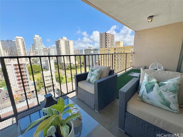 balcony with an outdoor hangout area and a city view