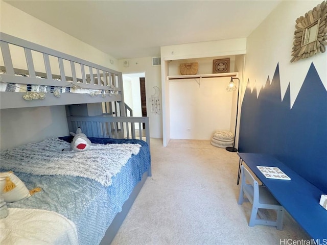 carpeted bedroom with a closet and visible vents