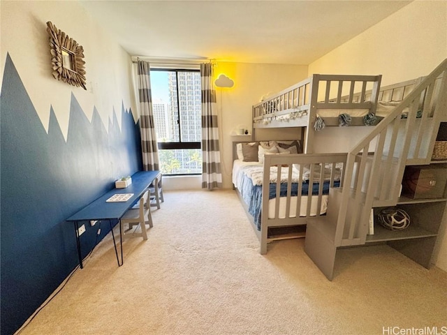 carpeted bedroom featuring a wall of windows