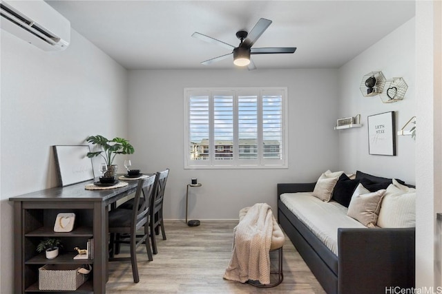 interior space featuring a ceiling fan, wood finished floors, and a wall mounted air conditioner