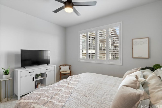 bedroom featuring a ceiling fan and carpet