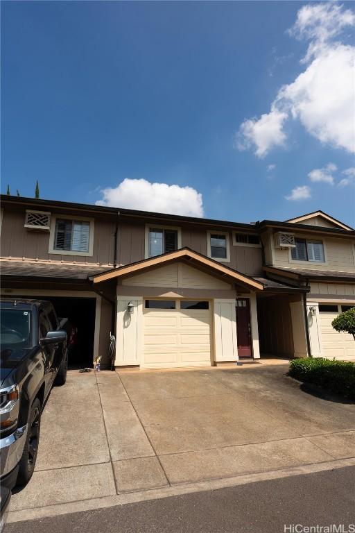 view of front of property with a garage, driveway, and board and batten siding