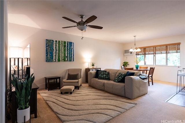 carpeted living room with an AC wall unit and ceiling fan with notable chandelier