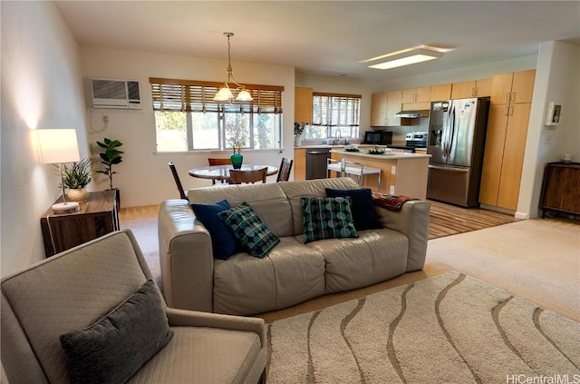 living area with light colored carpet and a wall mounted air conditioner