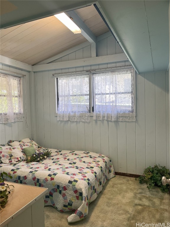 carpeted bedroom with lofted ceiling