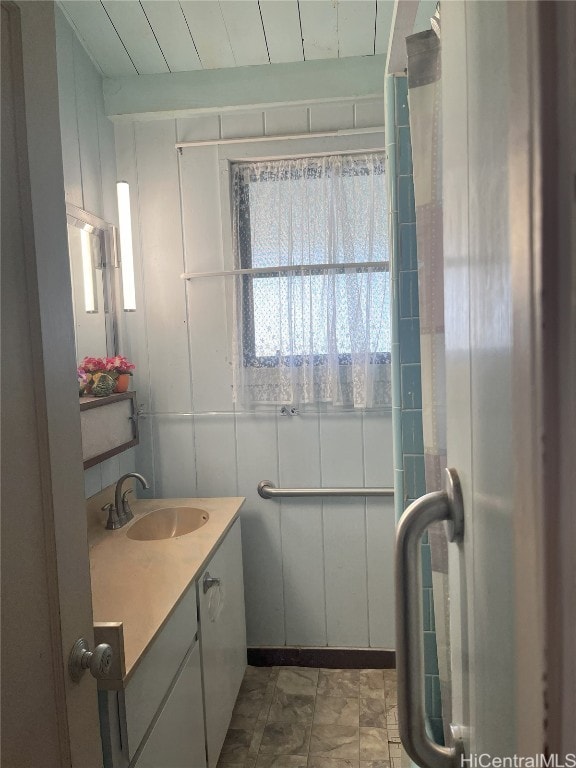 bathroom with wooden ceiling, beam ceiling, and vanity