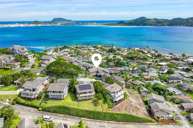 drone / aerial view featuring a residential view and a water and mountain view