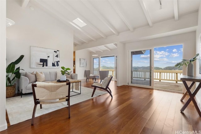 living room with high vaulted ceiling, wood finished floors, and beamed ceiling