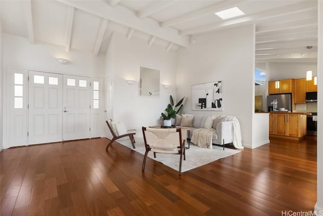 foyer entrance featuring high vaulted ceiling, dark wood-type flooring, and beam ceiling