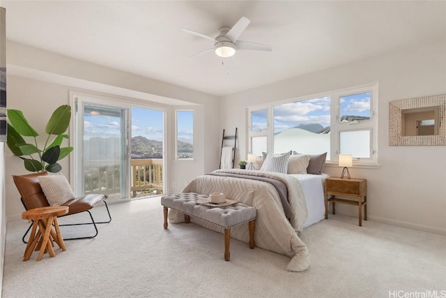 carpeted bedroom featuring access to exterior, baseboards, and a ceiling fan