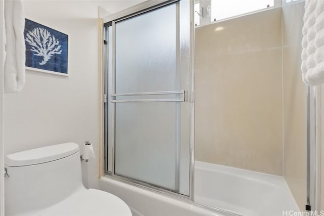 full bathroom with shower / bath combination with glass door and toilet