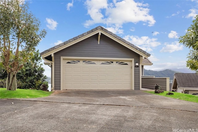 garage featuring a mountain view and concrete driveway