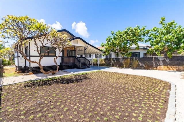 rear view of house featuring fence