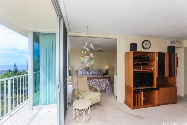 living area with carpet floors, visible vents, and a textured ceiling