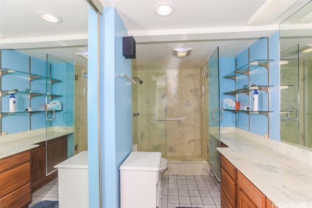 full bathroom featuring tile patterned flooring, vanity, and a shower stall