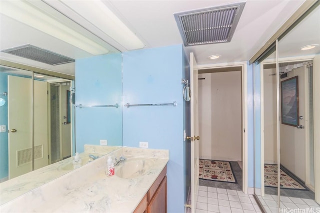 bathroom featuring vanity, visible vents, and tile patterned floors