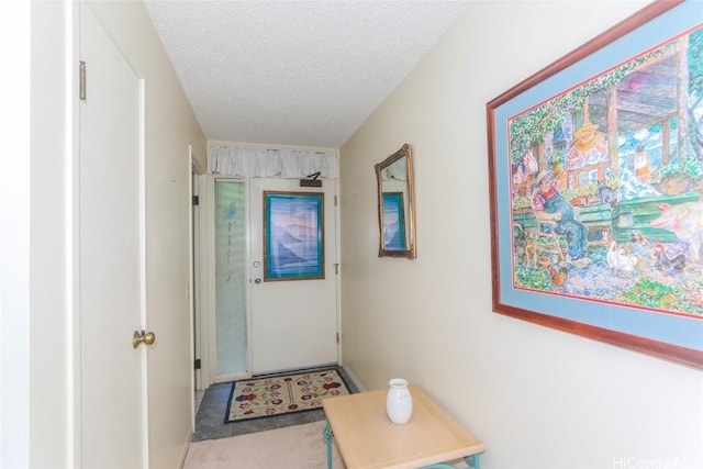 hallway with a textured ceiling