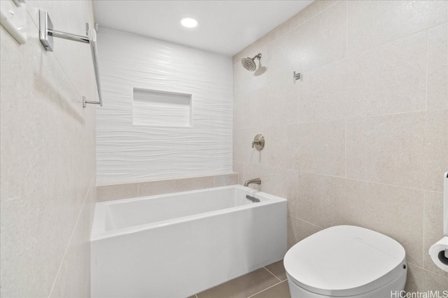 full bath with toilet, tile patterned floors, washtub / shower combination, tile walls, and recessed lighting