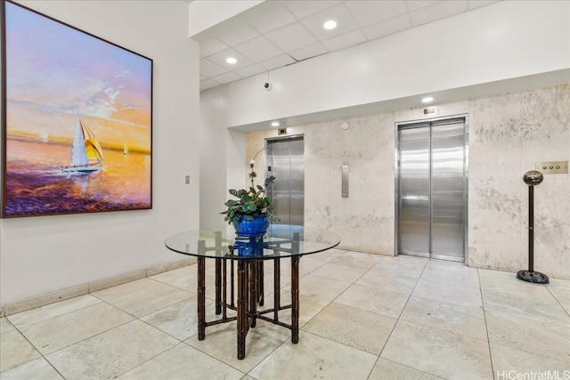 interior space with tile patterned flooring, elevator, and recessed lighting