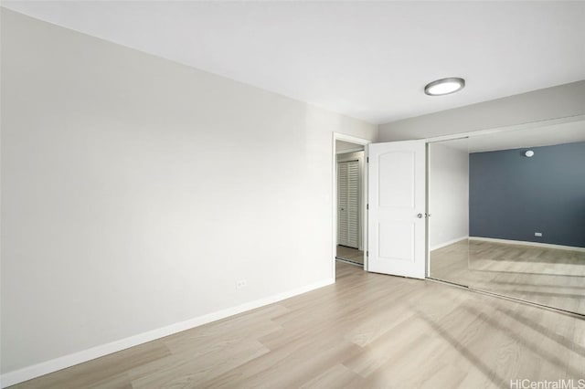 unfurnished room featuring baseboards and wood finished floors