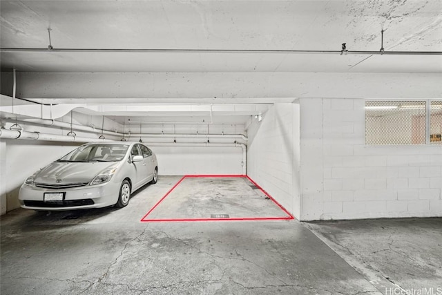 parking deck featuring concrete block wall