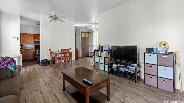 living area featuring ceiling fan and light wood-type flooring