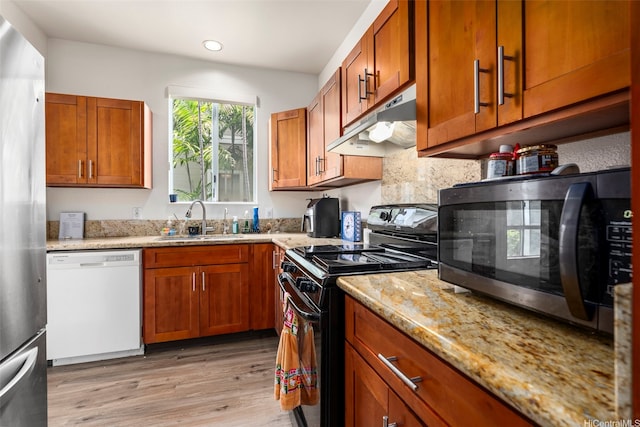 91-1058 Kekuilani Loop Unit 1804, Kapolei, HI 96707 - kitchen featuring stainless steel appliances, a sink, light wood-type flooring, light stone counters, and under cabinet range hood