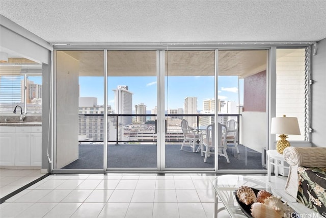 sunroom / solarium with a city view and a sink