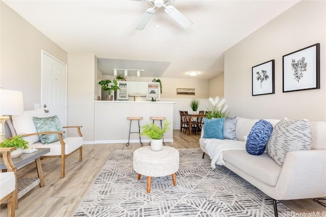 living area featuring ceiling fan and light wood-type flooring