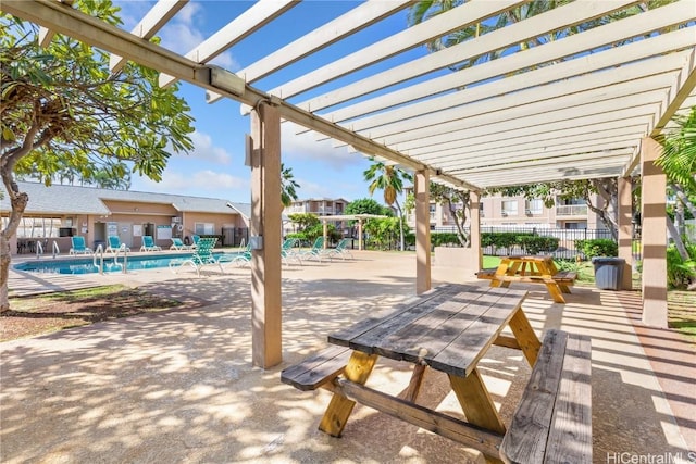 view of patio / terrace featuring fence, a community pool, and a pergola