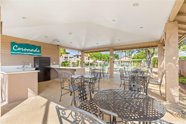 view of patio / terrace with outdoor dining area and a sink