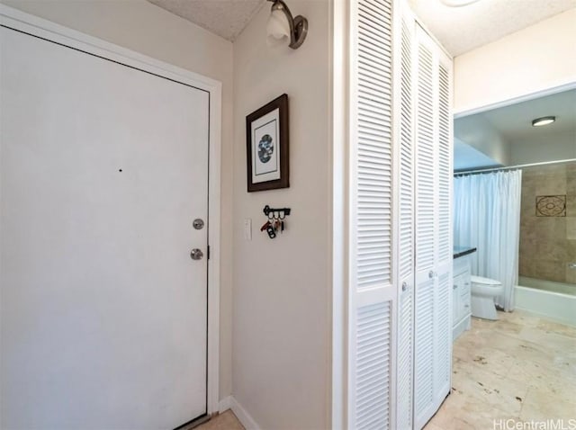 entryway featuring baseboards