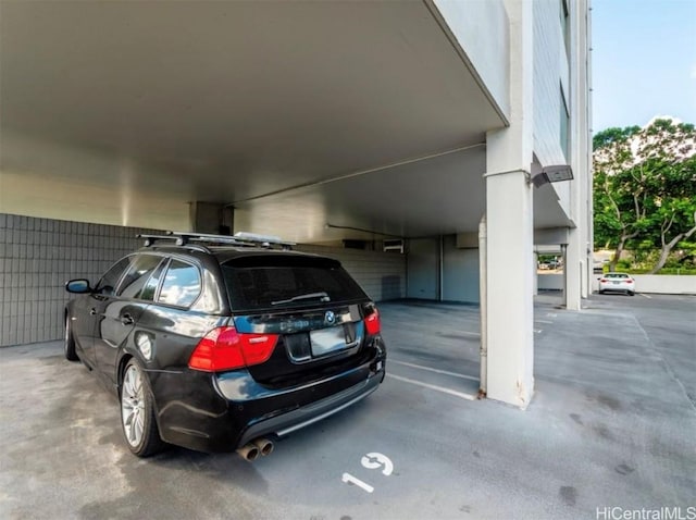 view of parking / parking lot with a parking garage