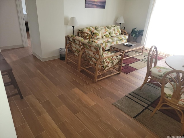 living room with baseboards and wood finished floors