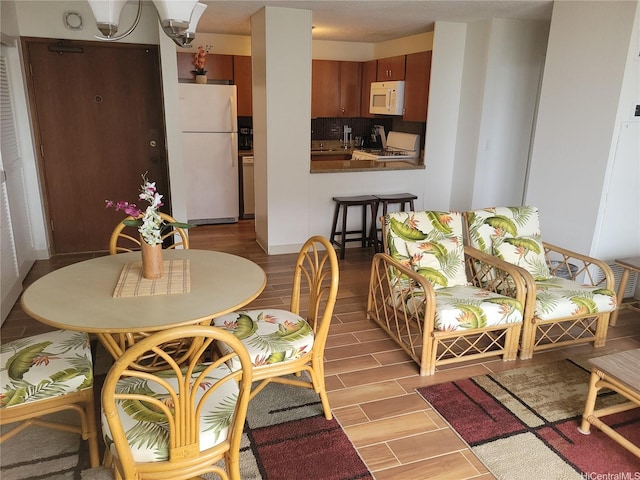 dining area featuring light wood-style flooring