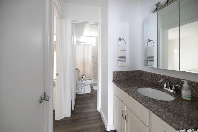 full bathroom with toilet, wood finished floors, vanity, and a shower with curtain