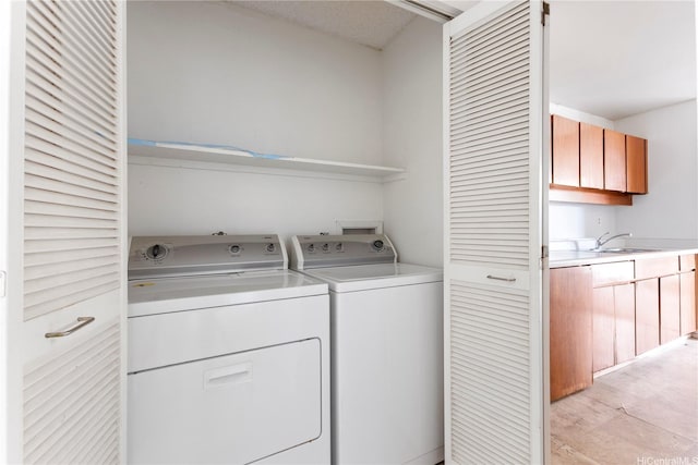 94-414 Kapuahi St Unit 23, Honolulu, HI 96789 - washroom featuring washer and clothes dryer and light wood-style flooring