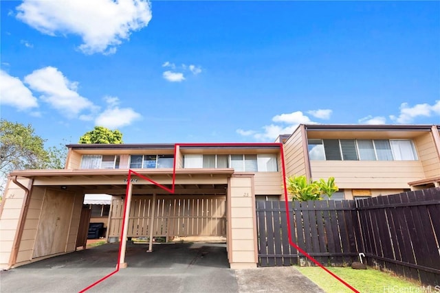 multi unit property featuring driveway and fence