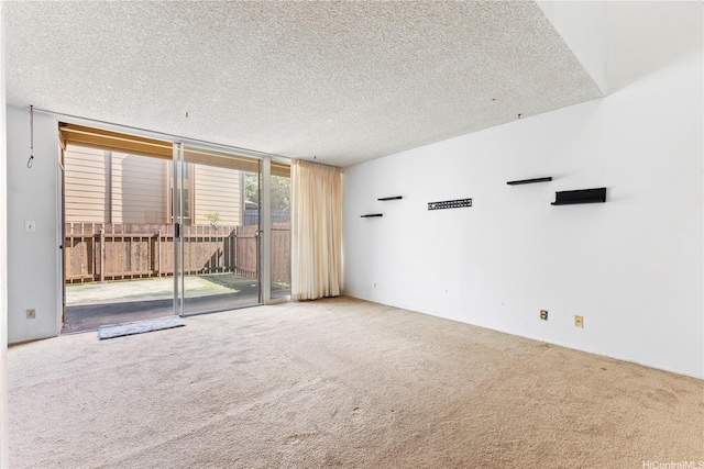 94-414 Kapuahi St Unit 23, Honolulu, HI 96789 - carpeted empty room with a wall of windows and a textured ceiling