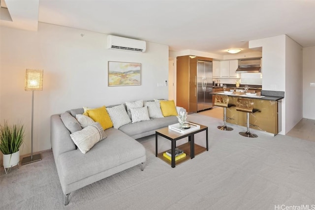 living room with a wall unit AC and light colored carpet