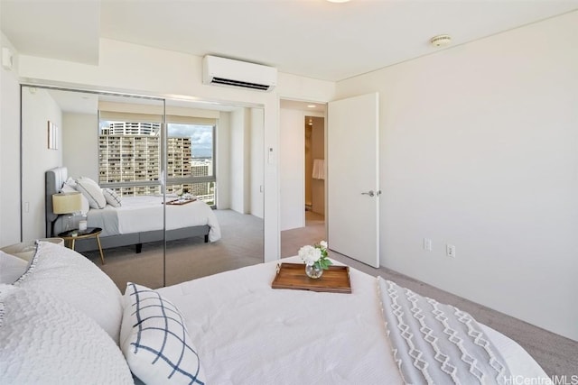 carpeted bedroom with a wall unit AC and a closet